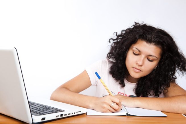 College Student learning in the library with a VPN